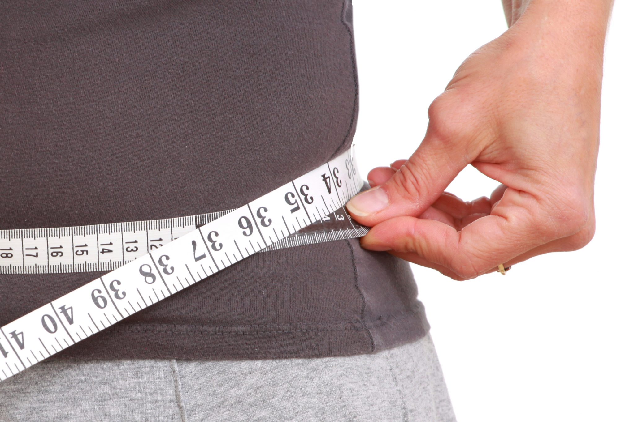 man measuring waist before medical weight loss